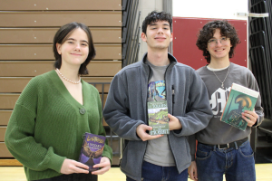  students posing with books